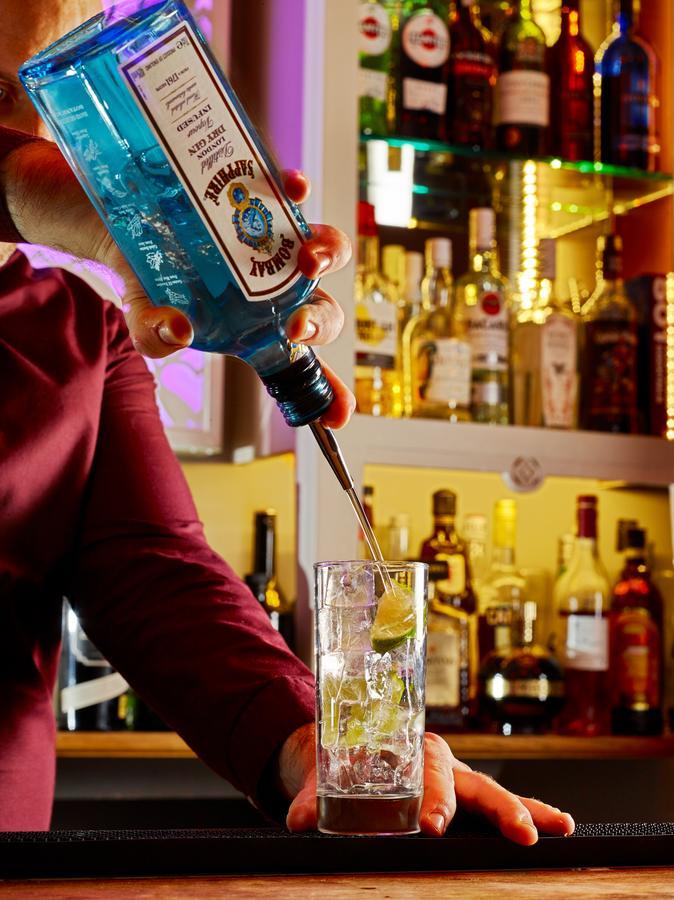 Cotswold Grange Bed and Breakfast Cheltenham Exteriör bild A bartender pouring a bottle of Blue Curaçao liqueur